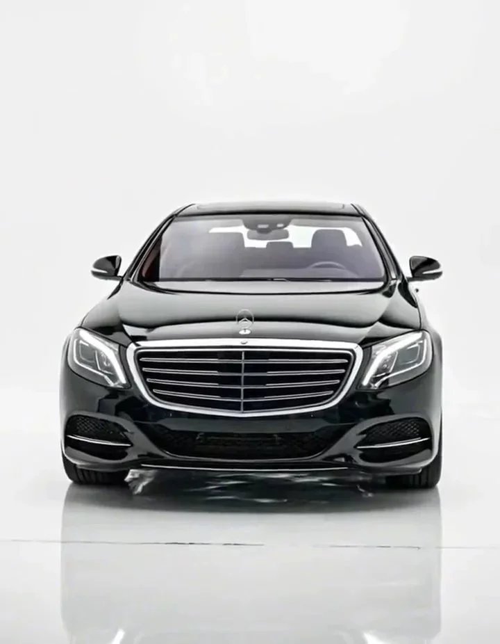 Black luxury sedan photo after AI car background replacement, shown in the app